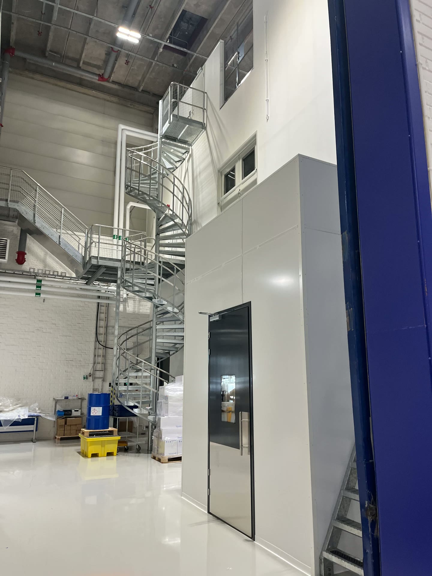 Cleanroom seen from the outside with spiral staircase and stainless steel doors