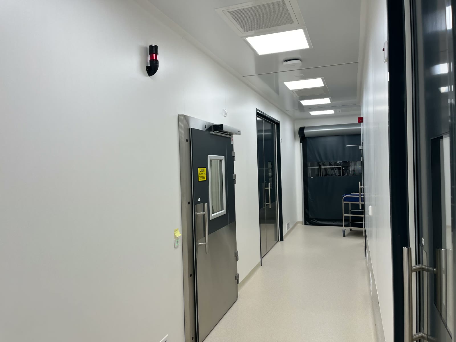 Cleanroom corridor with stainless steel doors and airlock